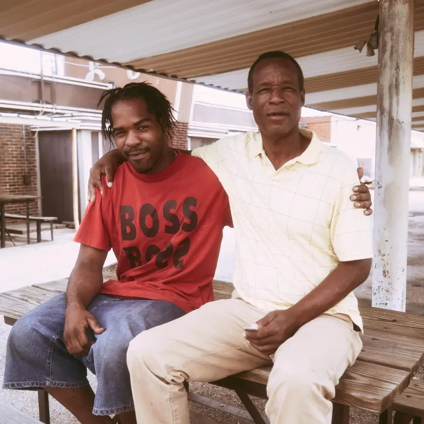 two men sitting on a bench